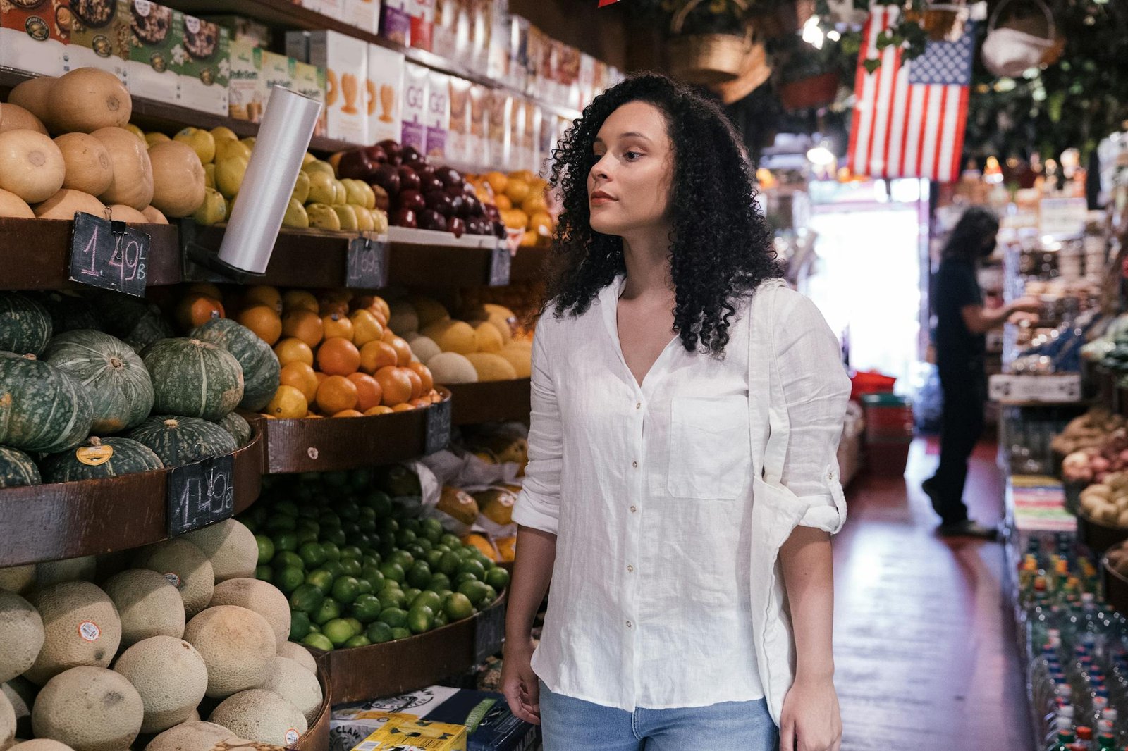 Woman exploring fresh produce and vegetables in a grocery store market.